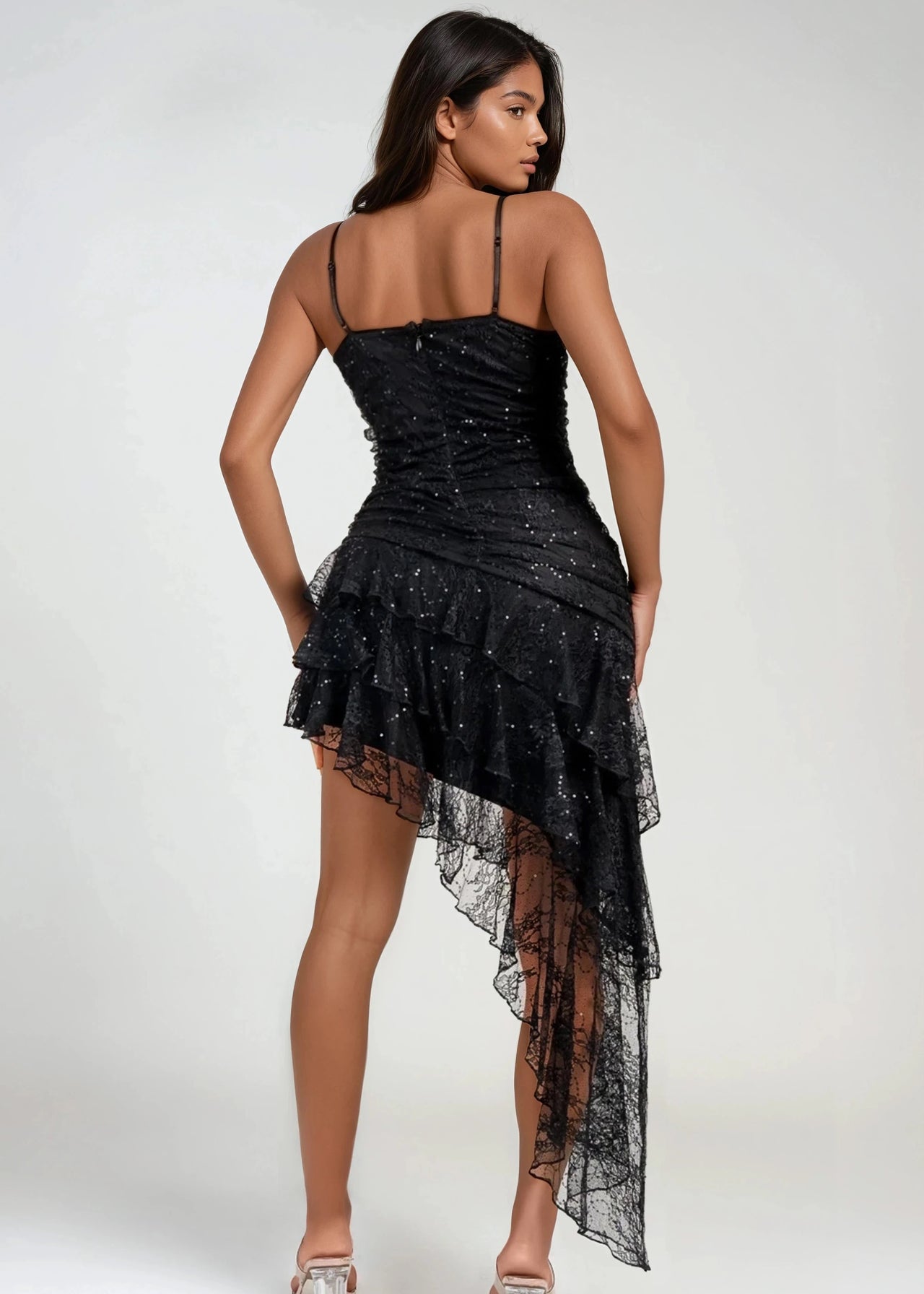Asymmetrical lace ruffle mini dress with bustier top and ruching.