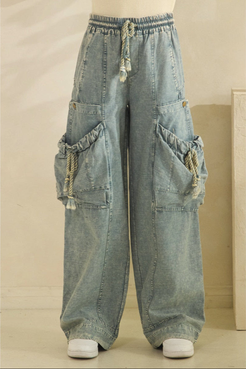 Light blue denim cargo pants on a neutral background