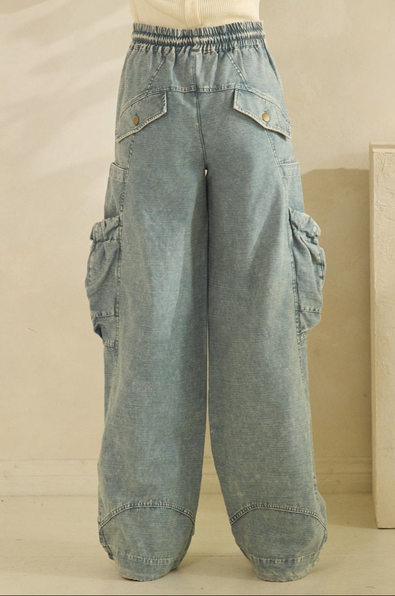 Light blue denim cargo pants on a beige background
