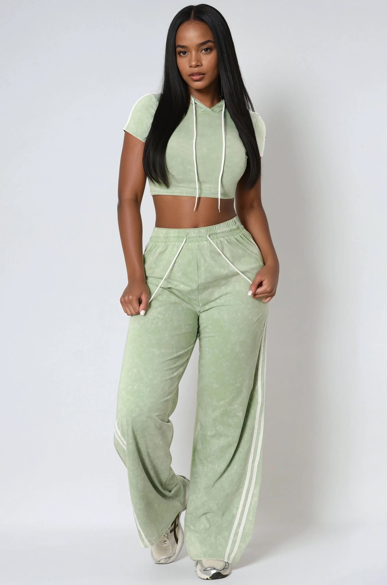 Two-piece cropped hoodie and jogger set in a mineral wash finish. Comfy fit with street-style edge for young women.