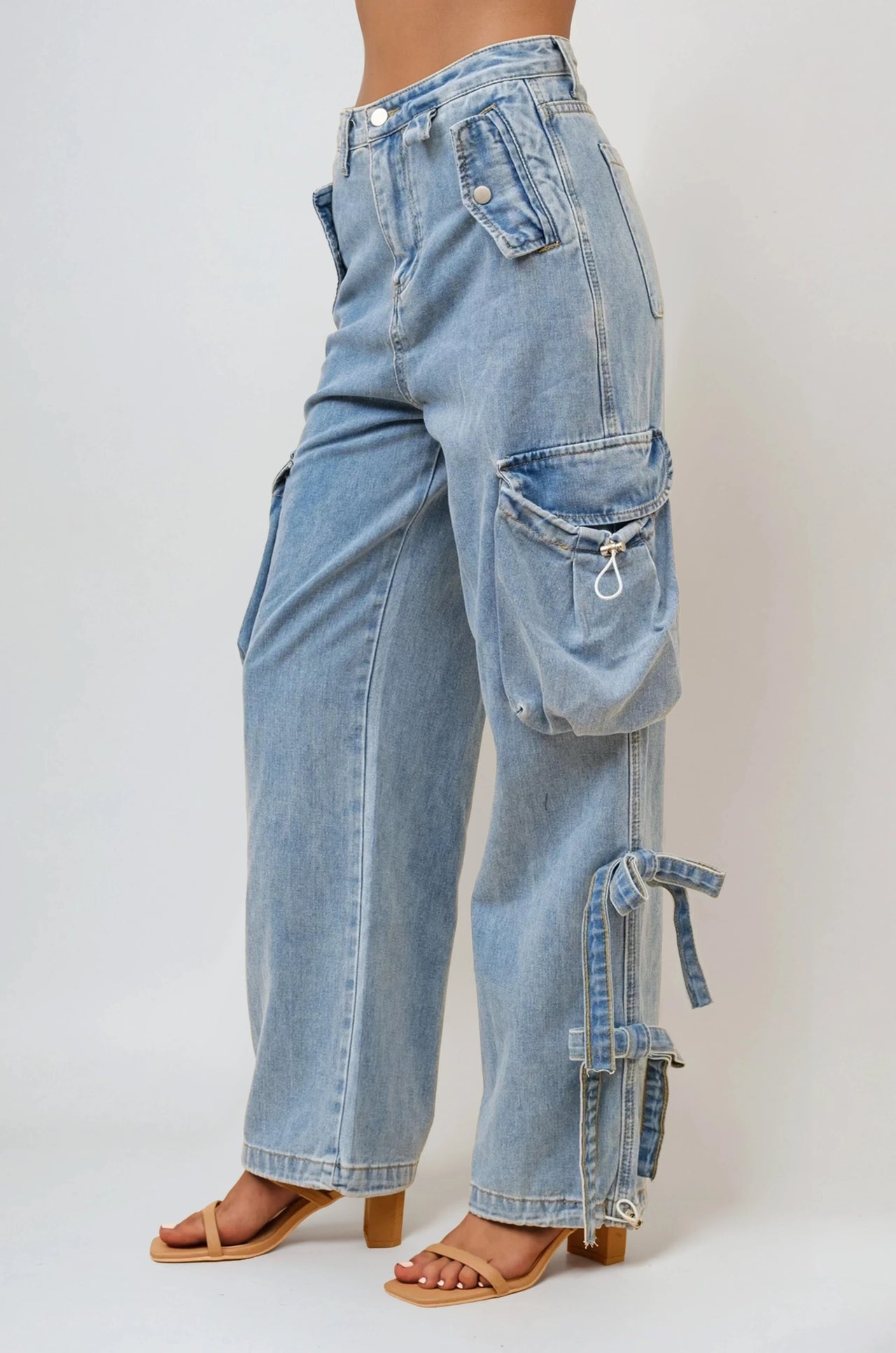 Women's soft-washed baggy denim cargo pants with utility pockets and bows