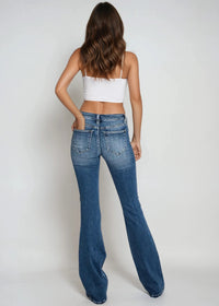 Thumbnail for Low-rise distressed flare jeans with exposed button fly and wide legs.