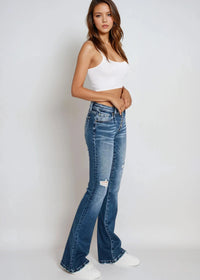 Thumbnail for Low-rise distressed flare jeans with exposed button fly and wide legs.