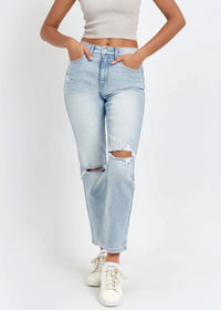 Thumbnail for Person wearing light blue distressed jeans and white sneakers on a white background