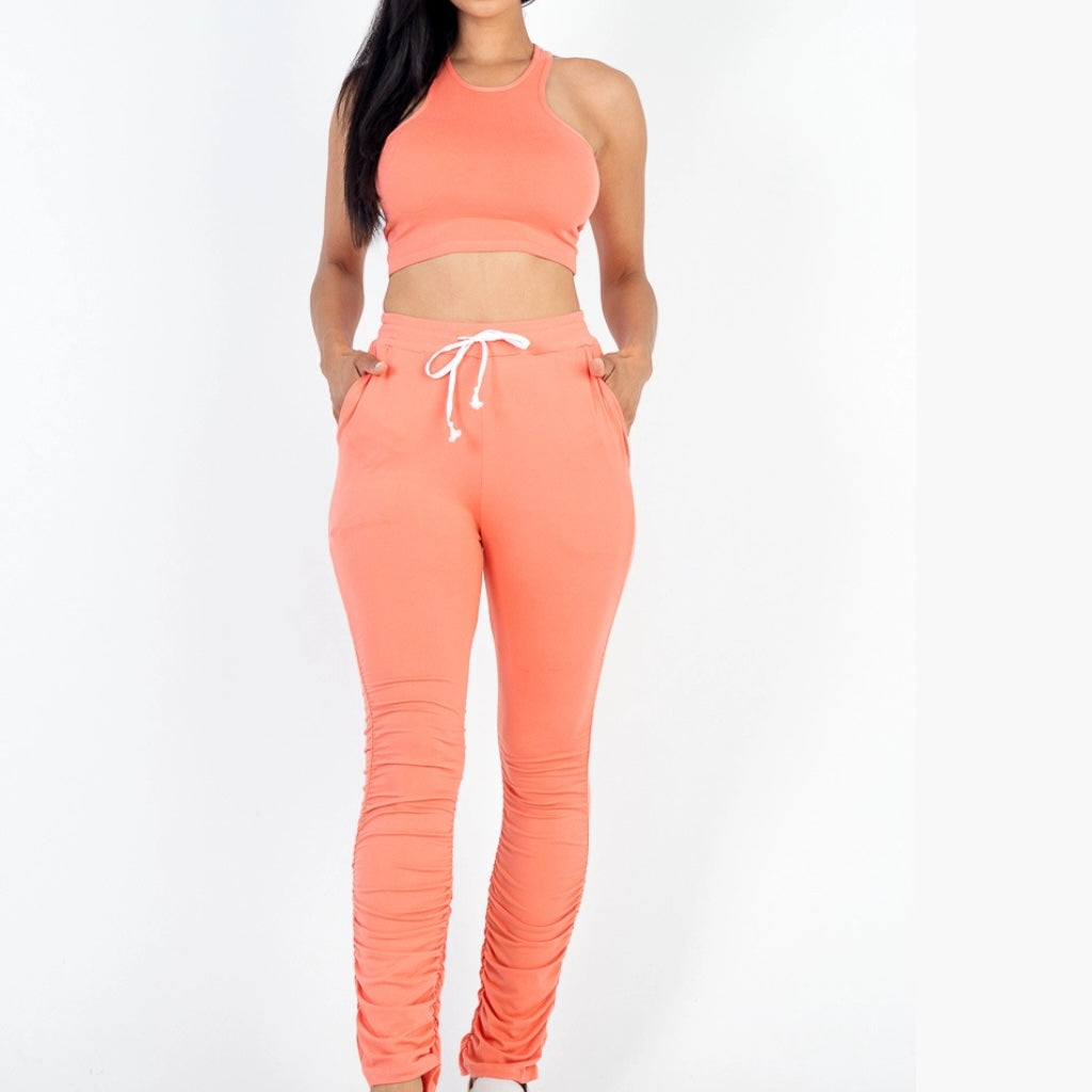 Lightweight two-piece crop top and ruched pants set for women. Front view.