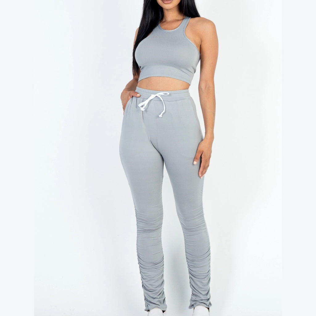 Lightweight gray two-piece crop top and ruched pants set for women. Front view.