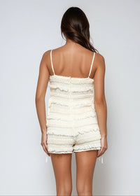 Thumbnail for Textured knit romper with smocking, adjustable straps, and side ties. Light, breezy, and softly powerful.