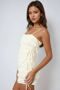 Thumbnail for Textured knit romper with smocking, adjustable straps, and side ties. Light, breezy, and softly powerful.