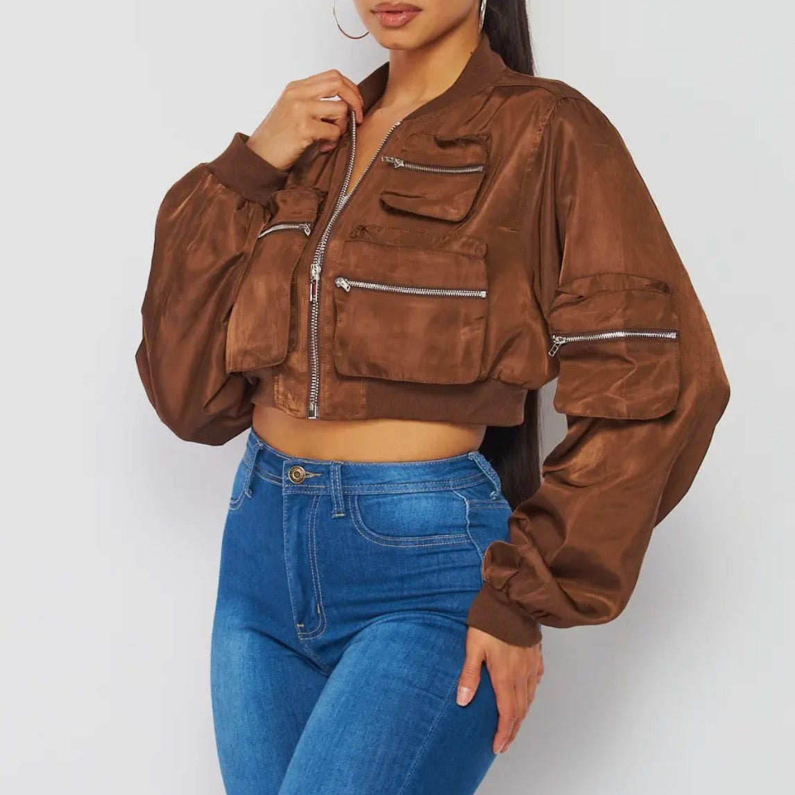 Trendy brown female bomber jacket, crop jacket with zipper details for spring and fall season. Side view.