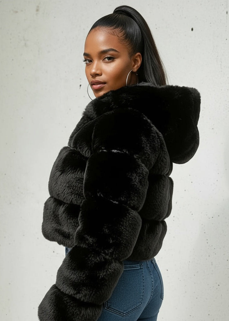 Woman wearing a black fur coat against a white background