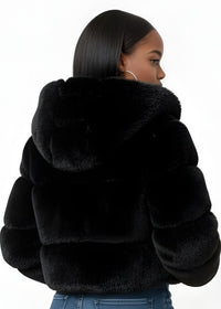 Thumbnail for Person wearing a black faux fur jacket and blue jeans on a white background