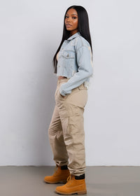 Thumbnail for Woman wearing a light blue denim jacket, beige cargo pants, and yellow boots against a white background