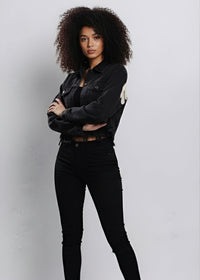 Thumbnail for Person wearing a black cropped denim jacket and black pants against a light gray background