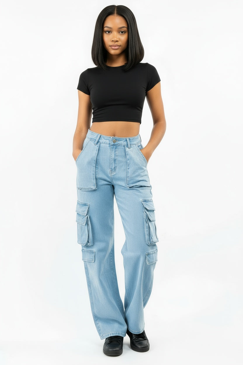 Person wearing pink seal light blue cargo pants and a black crop top on a white background