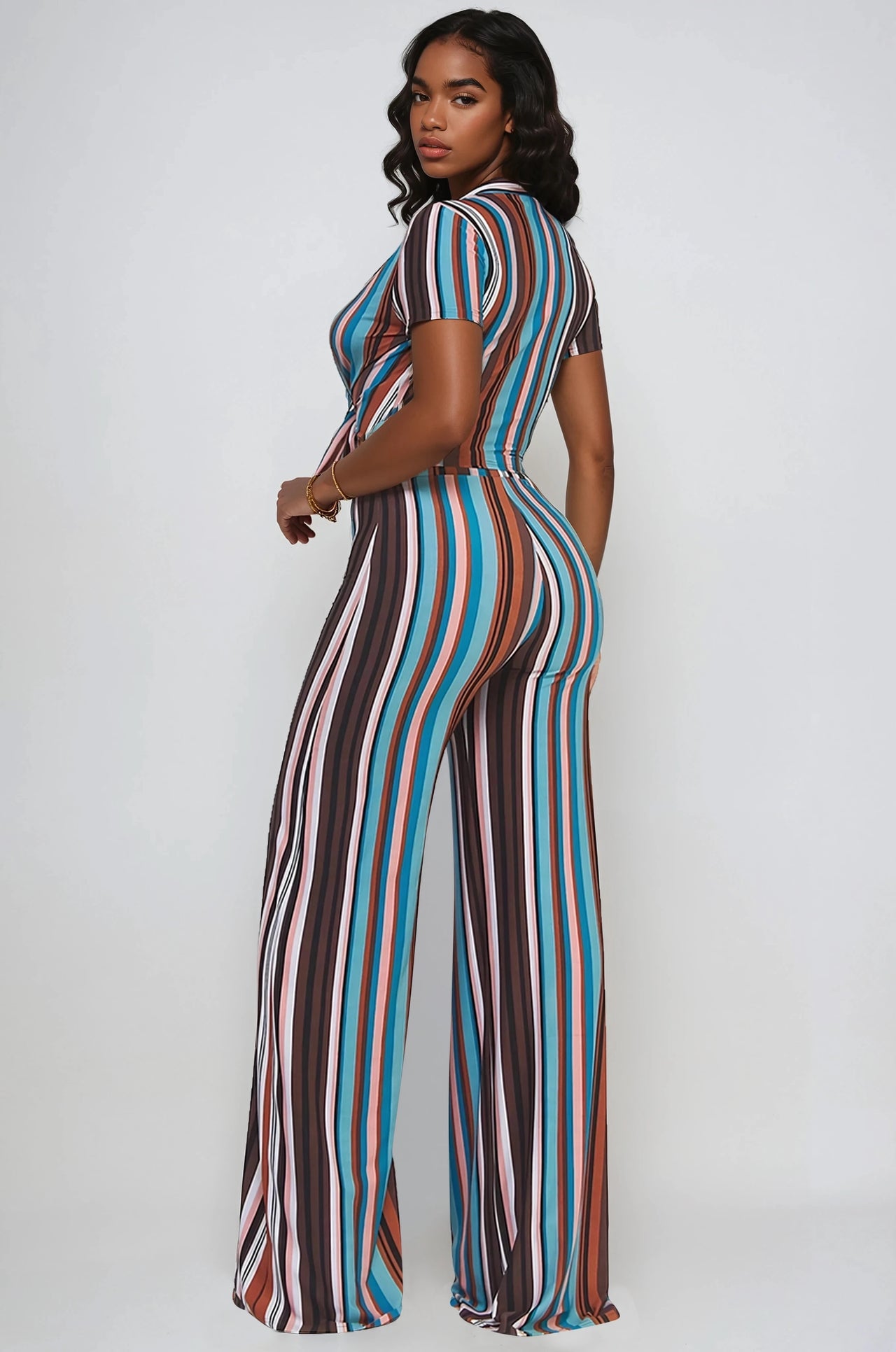 Woman wearing a Retro stripe 2-piece set with tie-front crop top and flare pants.