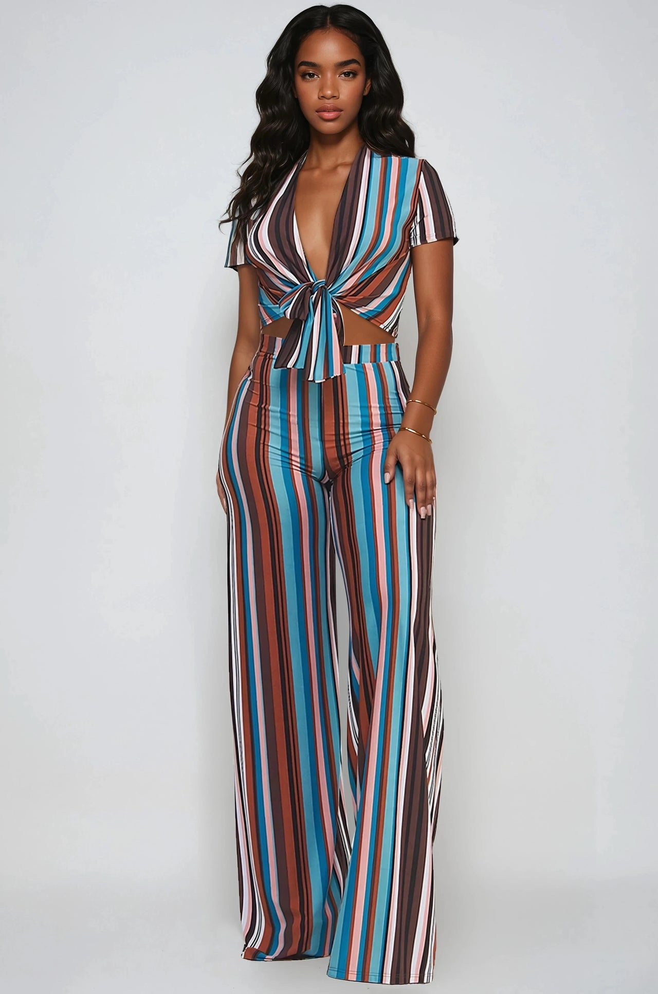 Woman wearing a Retro stripe 2-piece set with tie-front crop top and flare pants.