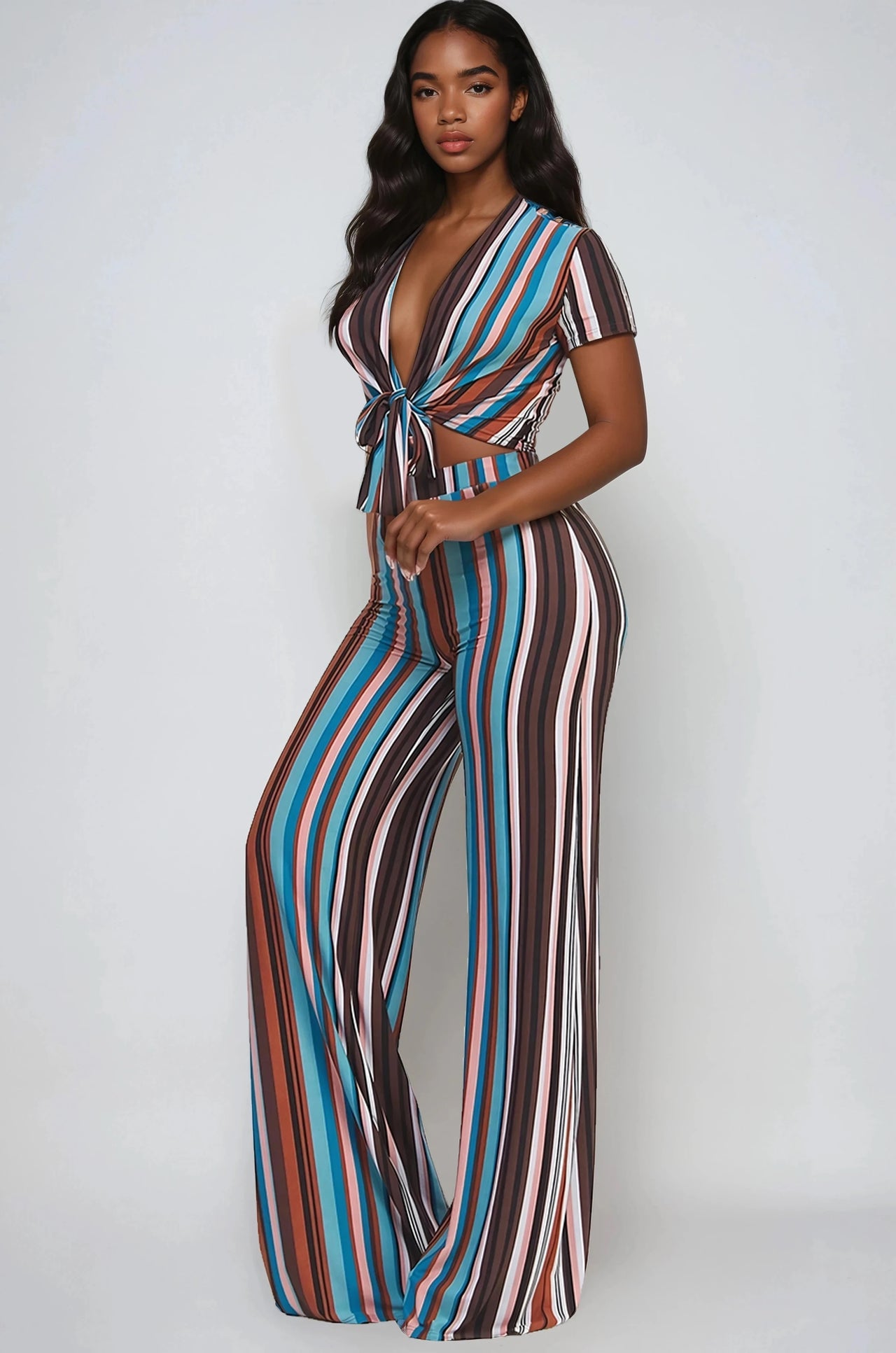 Woman wearing a Retro stripe 2-piece set with tie-front crop top and flare pants.