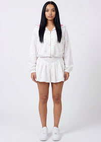 Thumbnail for Pink Seal Chic ruffle crop windbreaker and bubble skort in coquette print.