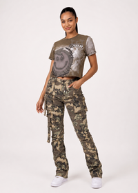 Thumbnail for A model wearing a cropped graphic t-shirt and high-waisted camouflage cargo pants, paired with white sneakers, against a plain light gray studio background.