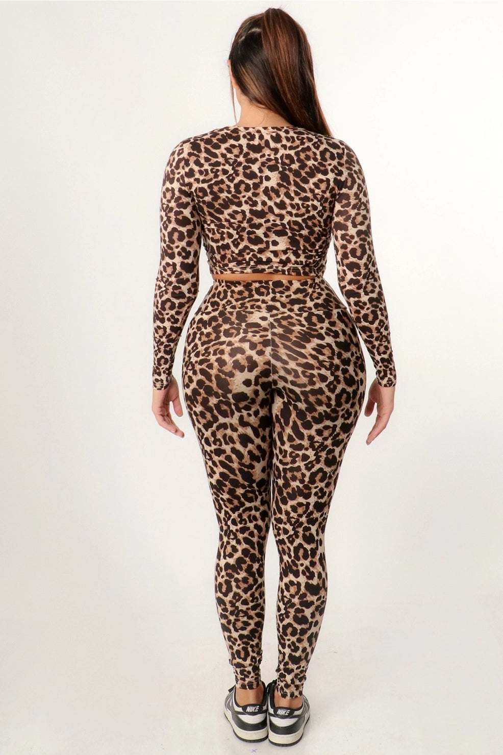 Matching long sleeve leopard crop top and leggings outfit for young women and teenagers. Ideal for gym, everyday wear, and lounging. Back view.