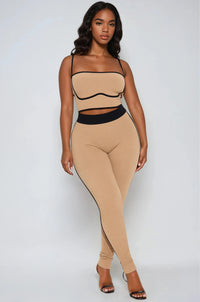 Thumbnail for Woman wearing a beige and black outfit on a white background