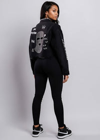 Thumbnail for Person wearing a black cropped denim jacket with white text on a gray background