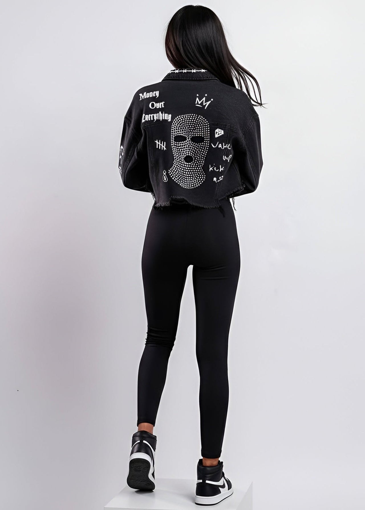 Person wearing a black outfit with text and graphics on a white background