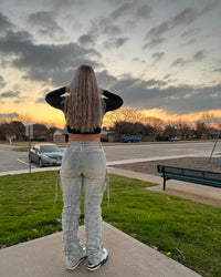 Thumbnail for Person standing on a sidewalk looking at a cloudy sky