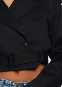 Thumbnail for Chic and bold, the cropped trench coat is made to evolve your look — shine louder in every step.
