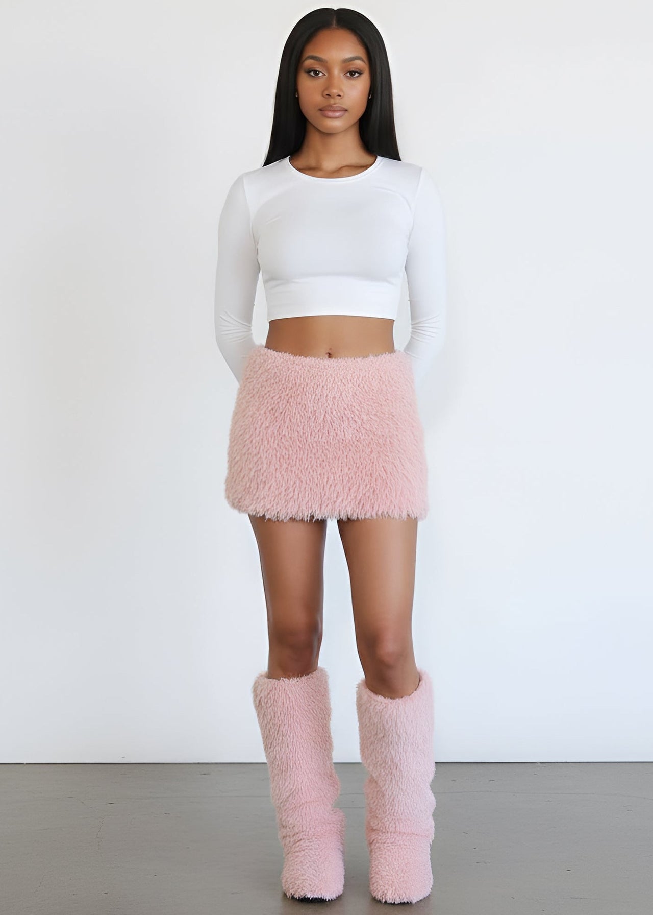 Women wearing a white top, Pink Seal Soft faux fur pink mini skirt with elastic waist and full lining.