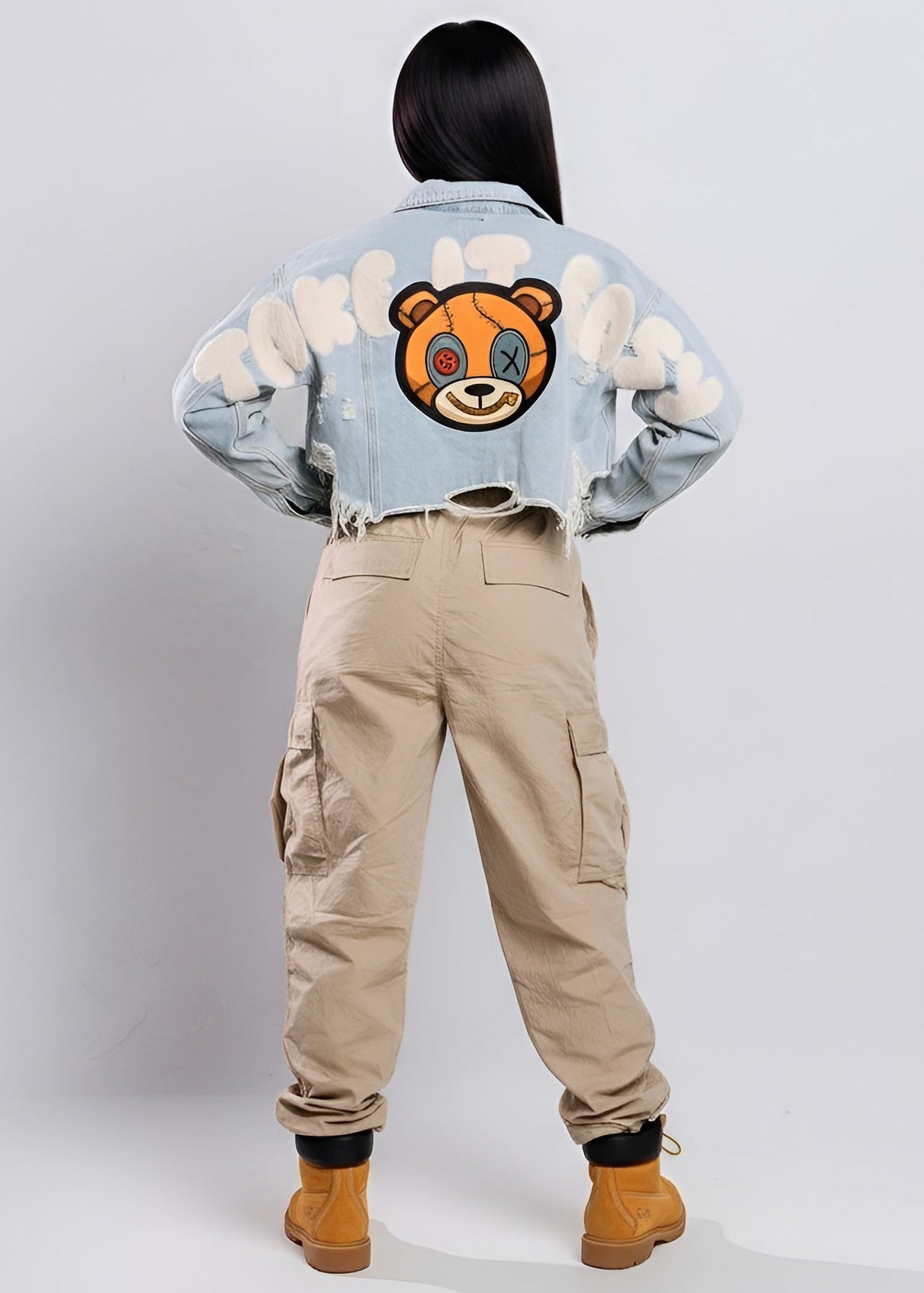 Pink Seal denim jacket with a bear face design and beige cargo pants on a white background