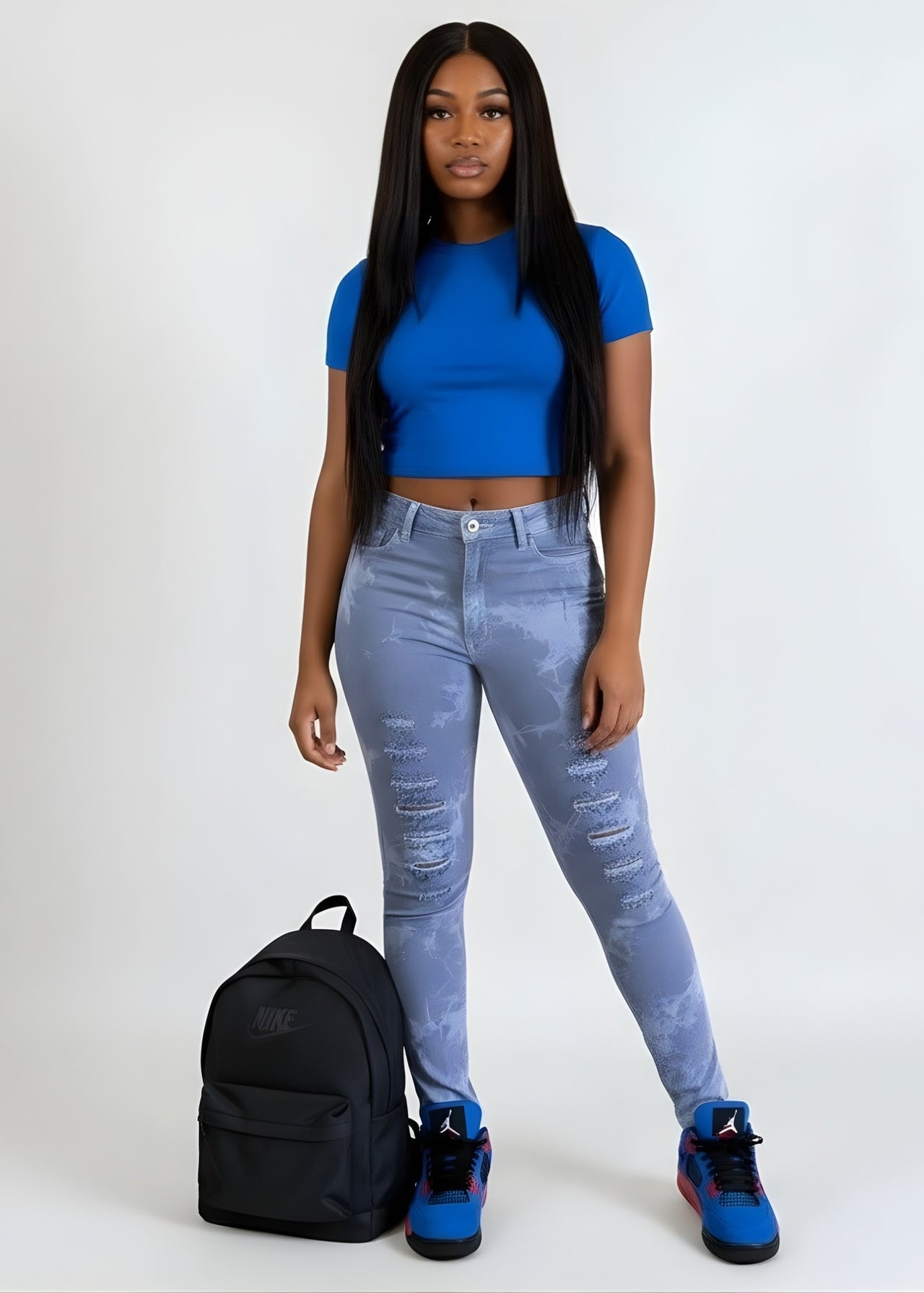 Pink Seal blue top and pink seal light blue jeans with a black backpack on a white background