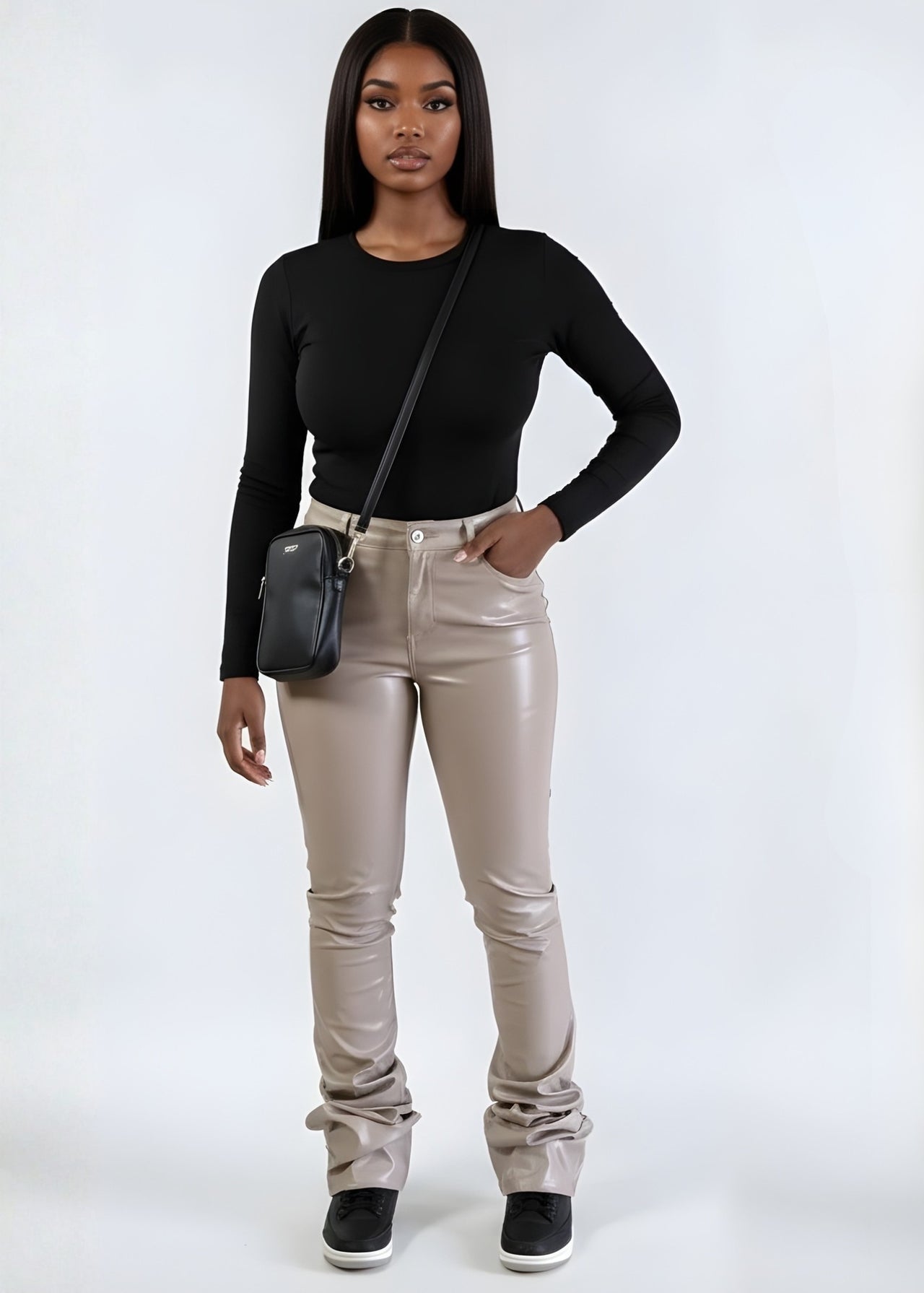 Pink Seal long-sleeve top and tan pants with a black bag 