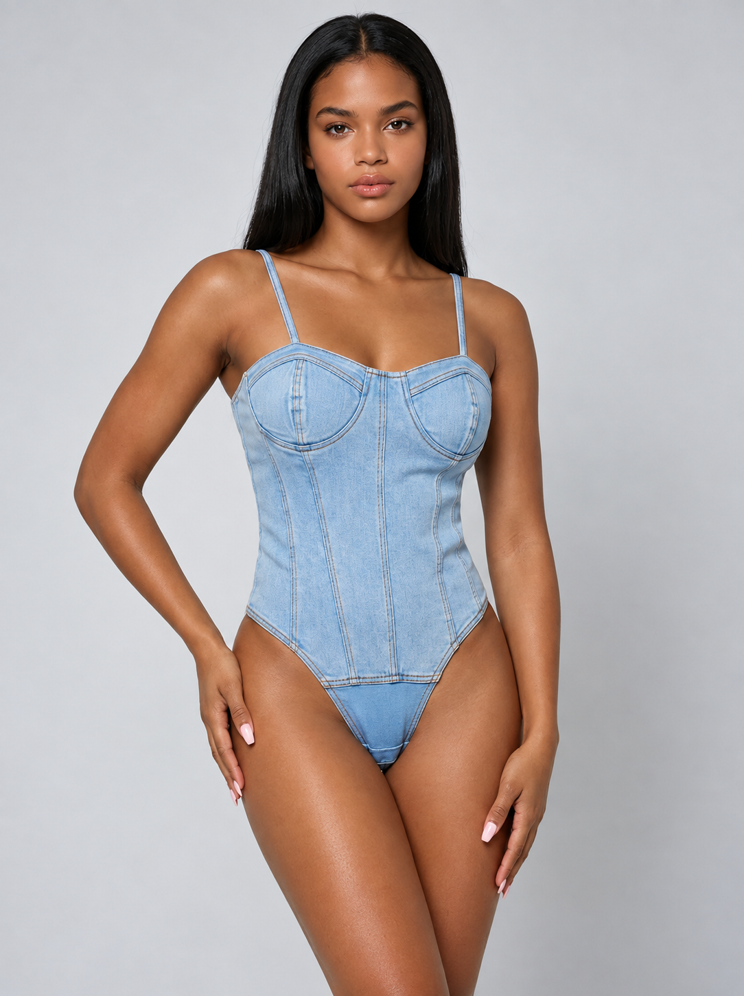 Lady wearing denim bodysuit with light grey joggers.