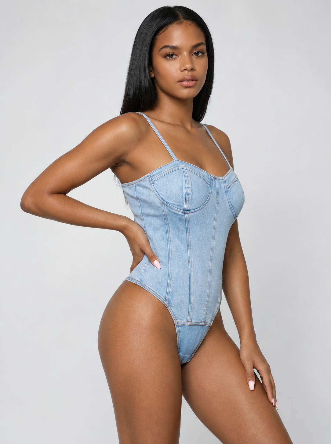 Lady wearing denim bodysuit with light grey joggers.