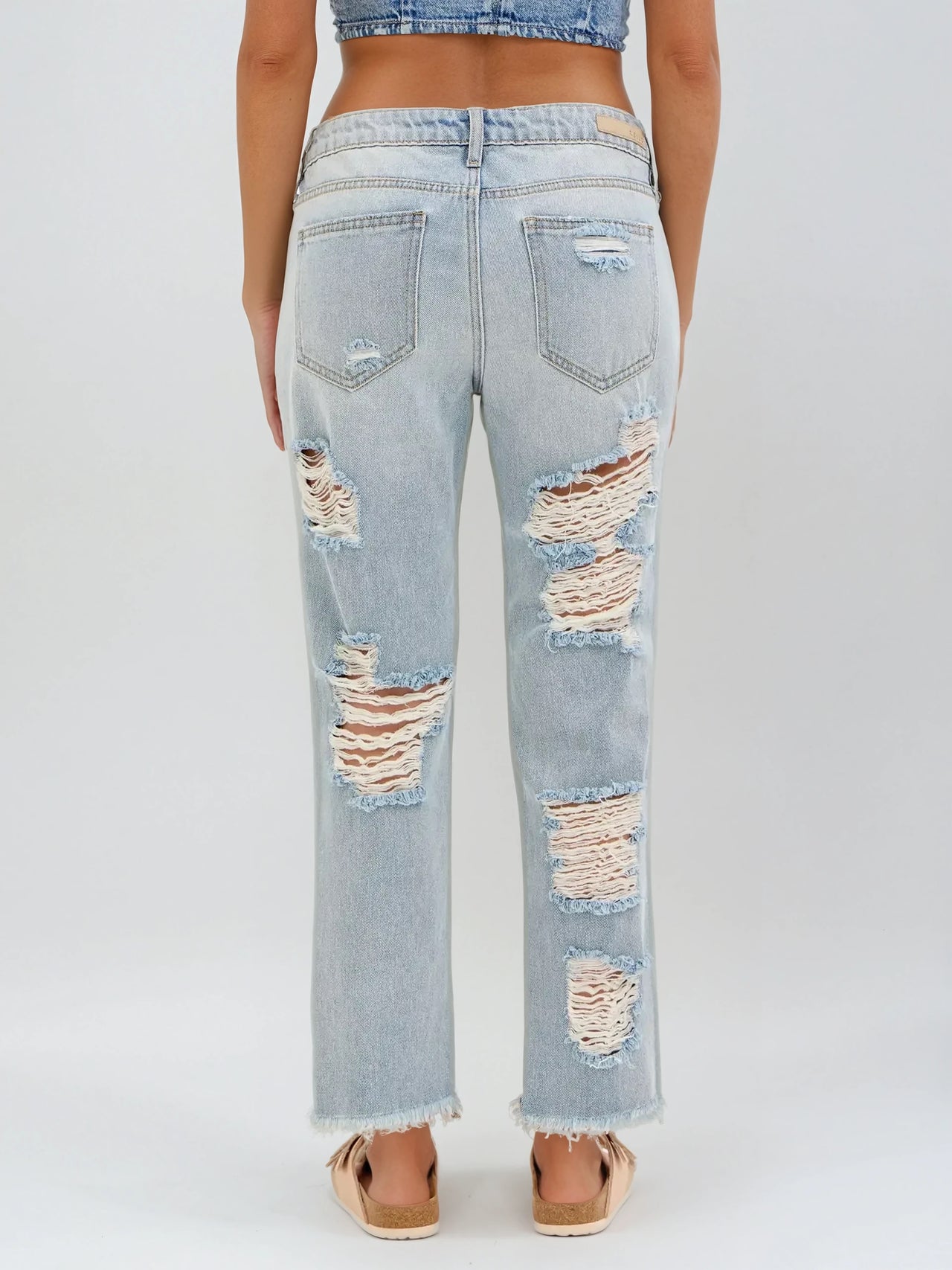 Light wash slouch Boyfriend jeans with frayed hems and distressed detailing. Bold streetwear with effortless edge.