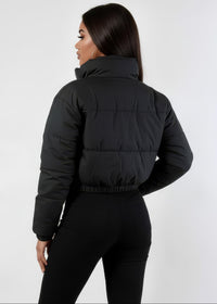 Thumbnail for Person wearing a black puffer winter down jacket and pants on a white background