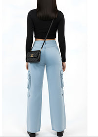 Thumbnail for Woman wearing a black long-sleeve top and Pink Seal light blue cargo pants, holding a black handbag on a white background.