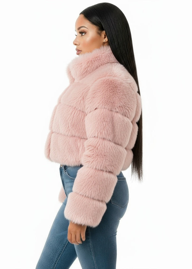 Woman wearing a pink fur jacket on a white background