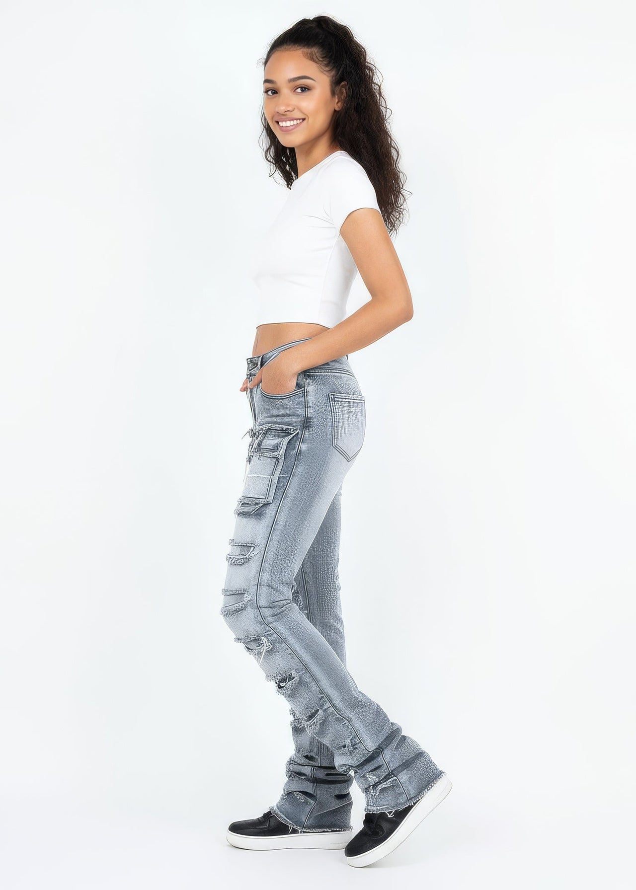 Woman wearing light blue jeans and a white top on a white background