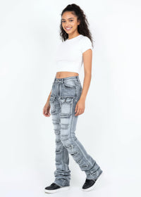 Thumbnail for Woman wearing light blue ripped jeans and a white crop top on a white background