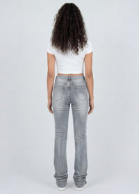 Thumbnail for Woman wearing light grey jeans and a white top on a white background
