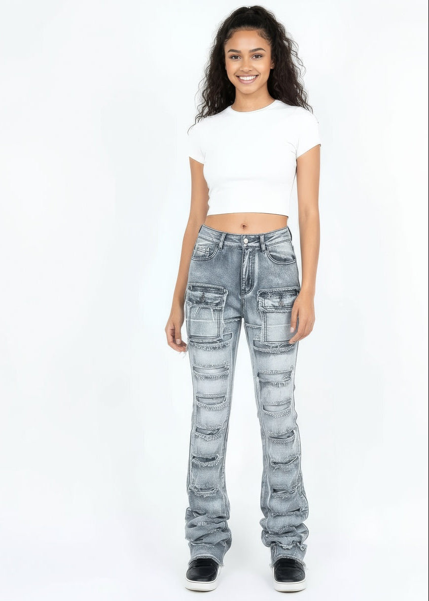 Woman wearing light blue distressed jeans and a white crop top on a white background