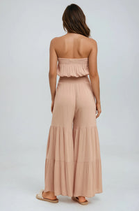 Thumbnail for Woman wearing a beige strapless top and wide-leg pants on a white background