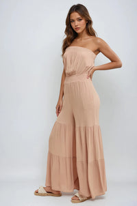 Thumbnail for Woman wearing a beige strapless jumpsuit on a white background