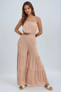 Thumbnail for Woman wearing a beige strapless jumpsuit on a white background