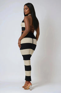 Thumbnail for Woman wearing a black and white striped outfit on a plain background