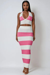 Thumbnail for Woman wearing a pink and white striped halter top and maxi skirt on a plain background