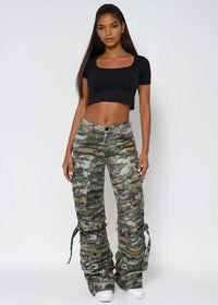 Thumbnail for Woman wearing Pink Seal camouflage pants and a black top on a white background