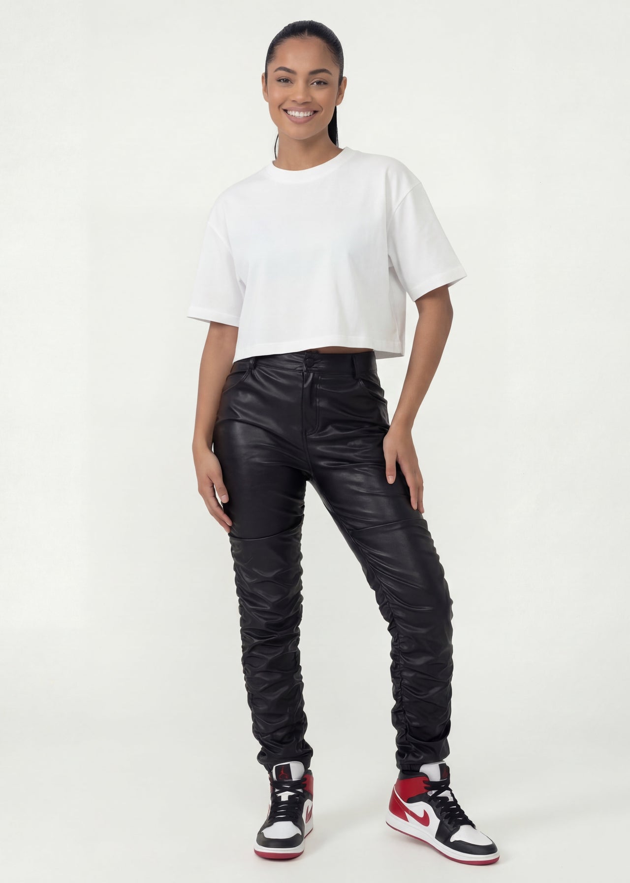 Pink Seal High-rise thick PU leather pants with ruched detailing.
